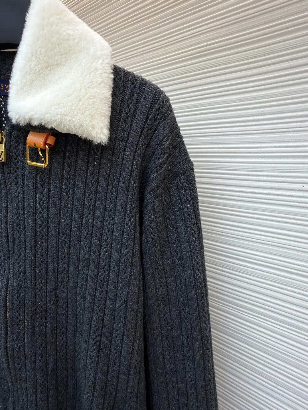 LOUIS VUITTON Cashmere Wool Zipper Tunic Jacket ●Original version: Purchased and developed by 46989 ●Item number: 1682189-C00 ●Fabric: wool blended fabric ●Technology: knitted ●Color: gray ●Version: fitted version ●Weight: about 855 grams ●Size: S-M-L-XL ●Description: This LOUIS VUITTON FW25 cashmere wool zippered belted jacket. The fabric is made of rare cashmere and merino wool blended. It has been combed to remove impurities. It is knitted with 16-needle fine gauge to create a three-dimensional vertical pit stripe texture. The pit stripes are accurately positioned by a computer jacquard machine, with even spacing and a strong three-dimensional effect. The collar is made of high-quality mink fur, which is trimmed and shaped by hand. The fur is fluffy and smooth. It is decorated with metal buckles and leather patches. The leather patches are vegetable tanned, with a delicate texture and wear resistance. The placket has a custom-made metal zipper with electroplated and polished teeth. The zipper and body are fixed by hand caulking, and the stitching is hidden and firm. The waist girdle structure uses built-in elastic webbing, combined with ergonomic three-dimensional tailoring. The cuffs and hem are designed with ribbed edges and are pre-shrunk at high temperatures to prevent them from loosening. The overall sewing has gone through multiple quality control processes. From fabric weaving to detail assembly, the brand's strict craftsmanship standards are followed, showing the quality of luxury craftsmanship. The overall wiring is straight and delicate, the fabric is comfortable and soft, and the color is consistent without color difference. It can be matched with the same style to create a fashionable look and control various occasions. Customized accessories, complete with three standards, same style for men and women!